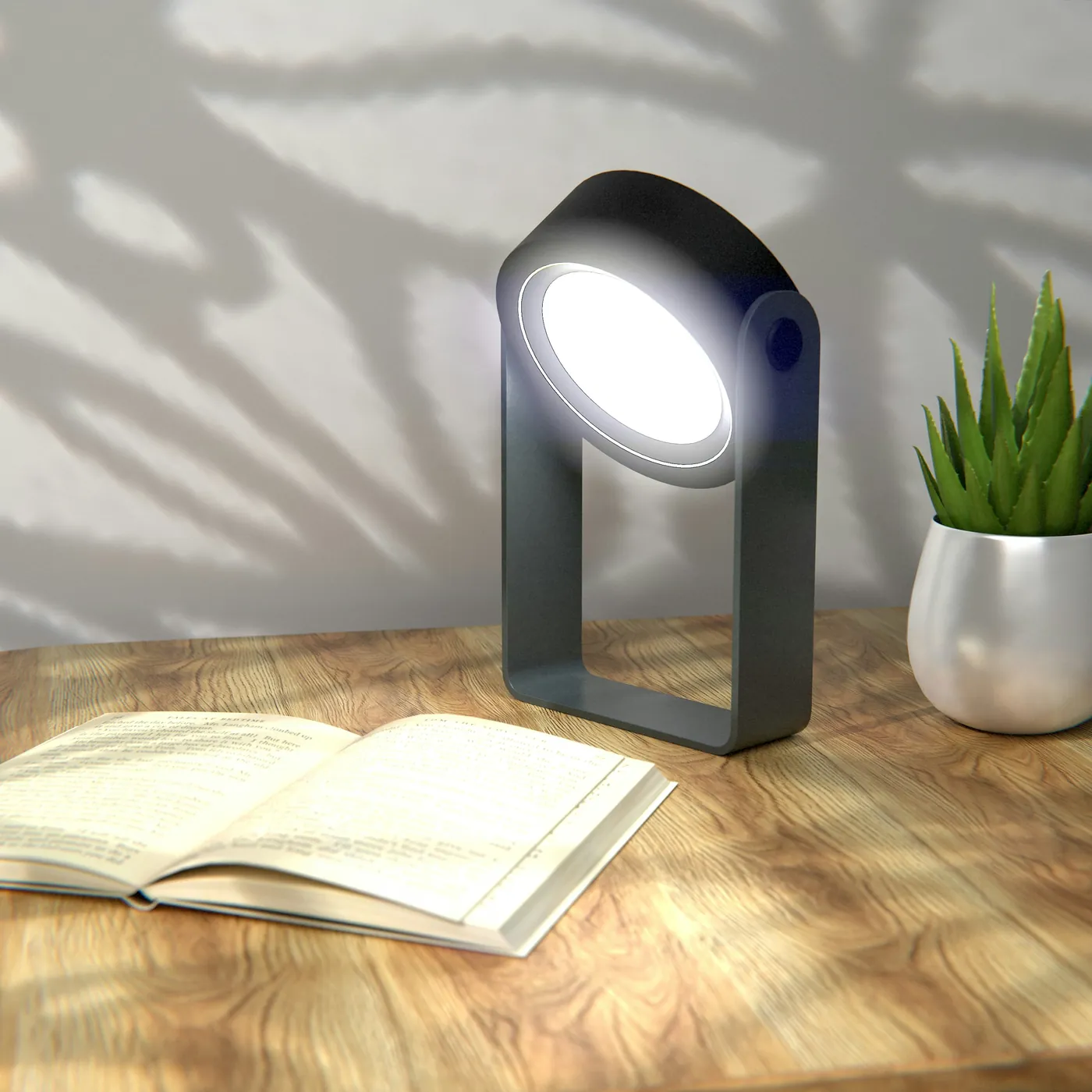 Open book and lamp arranged on a wooden desk